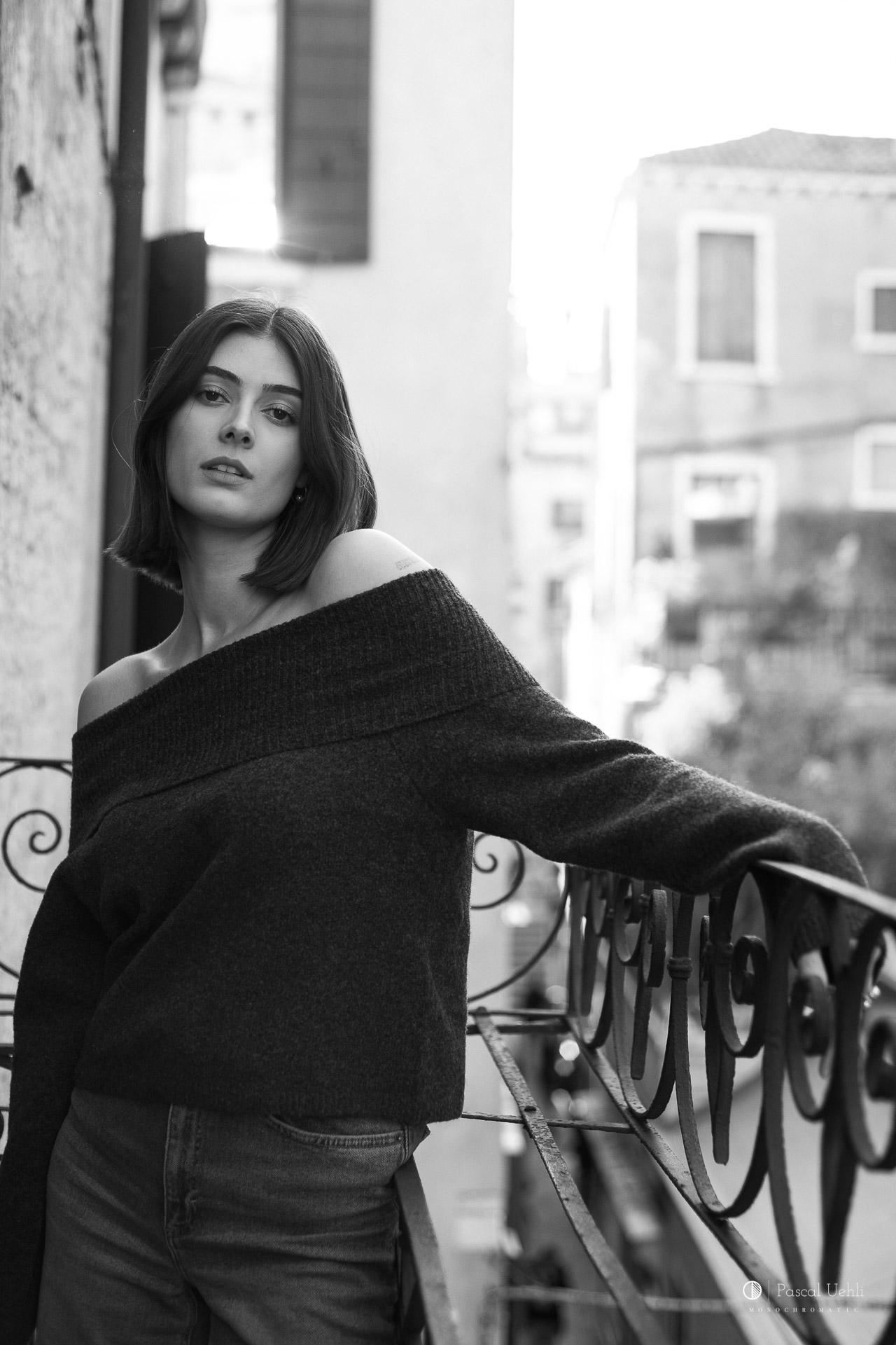 Dayane Hofer on a Venetian balcony in a black and white portrait by Pascal Uehli