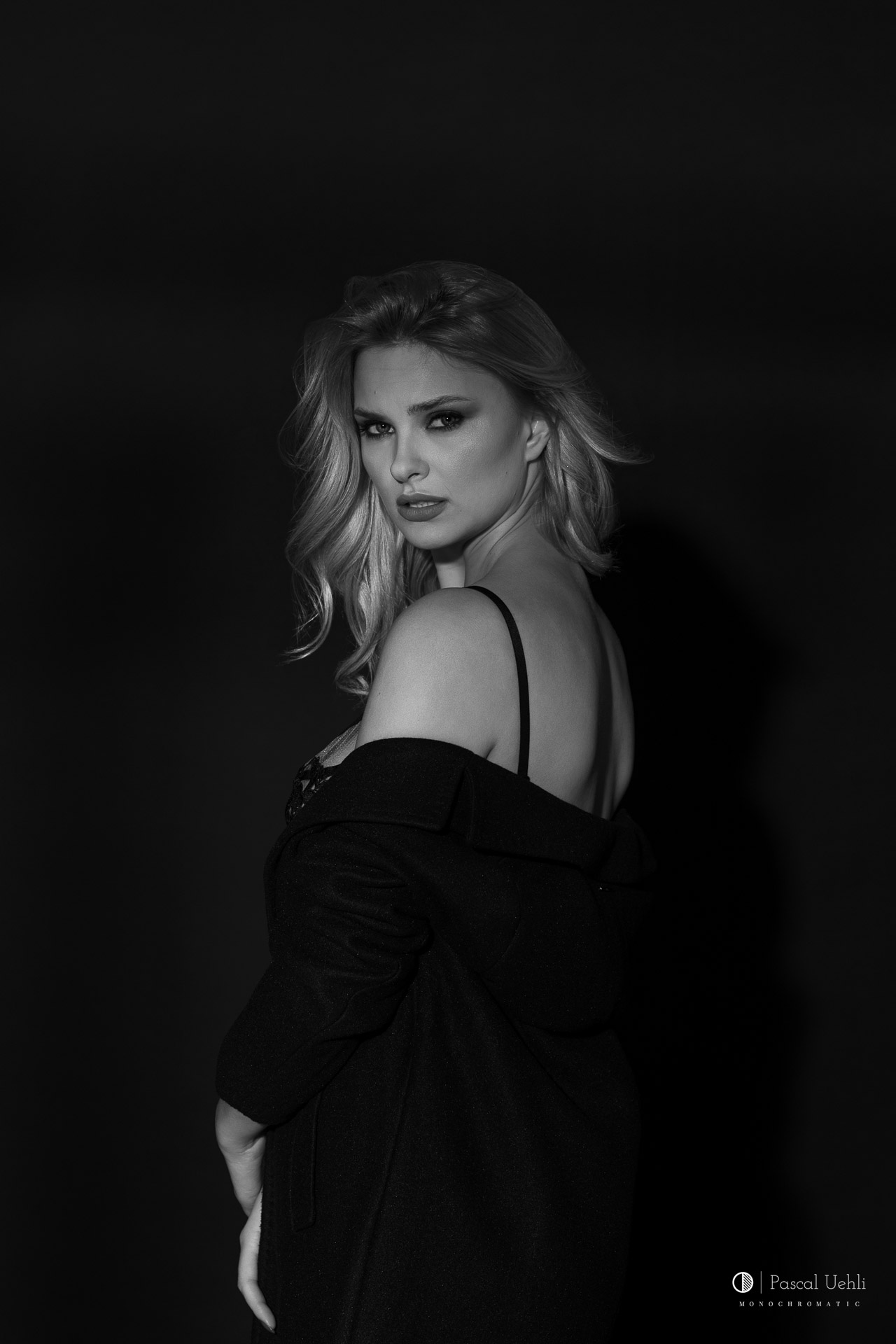 Carla in a black and white studio portrait by Pascal Uehli